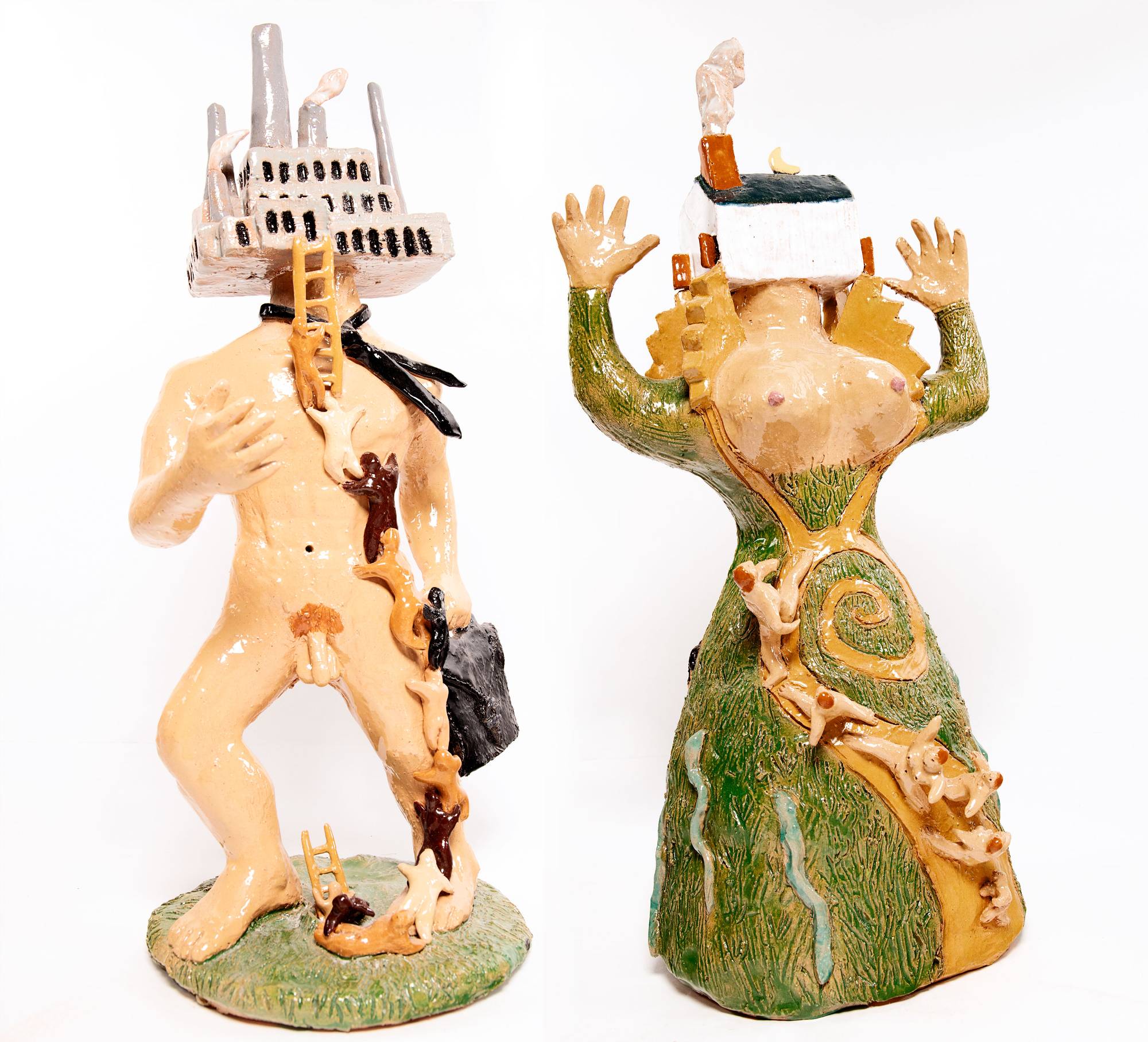 Two ceramic sculpture of human figures with no heads. Instead, one figure has a factory in place of their head, the other a house. Both have small figures climbing up them.